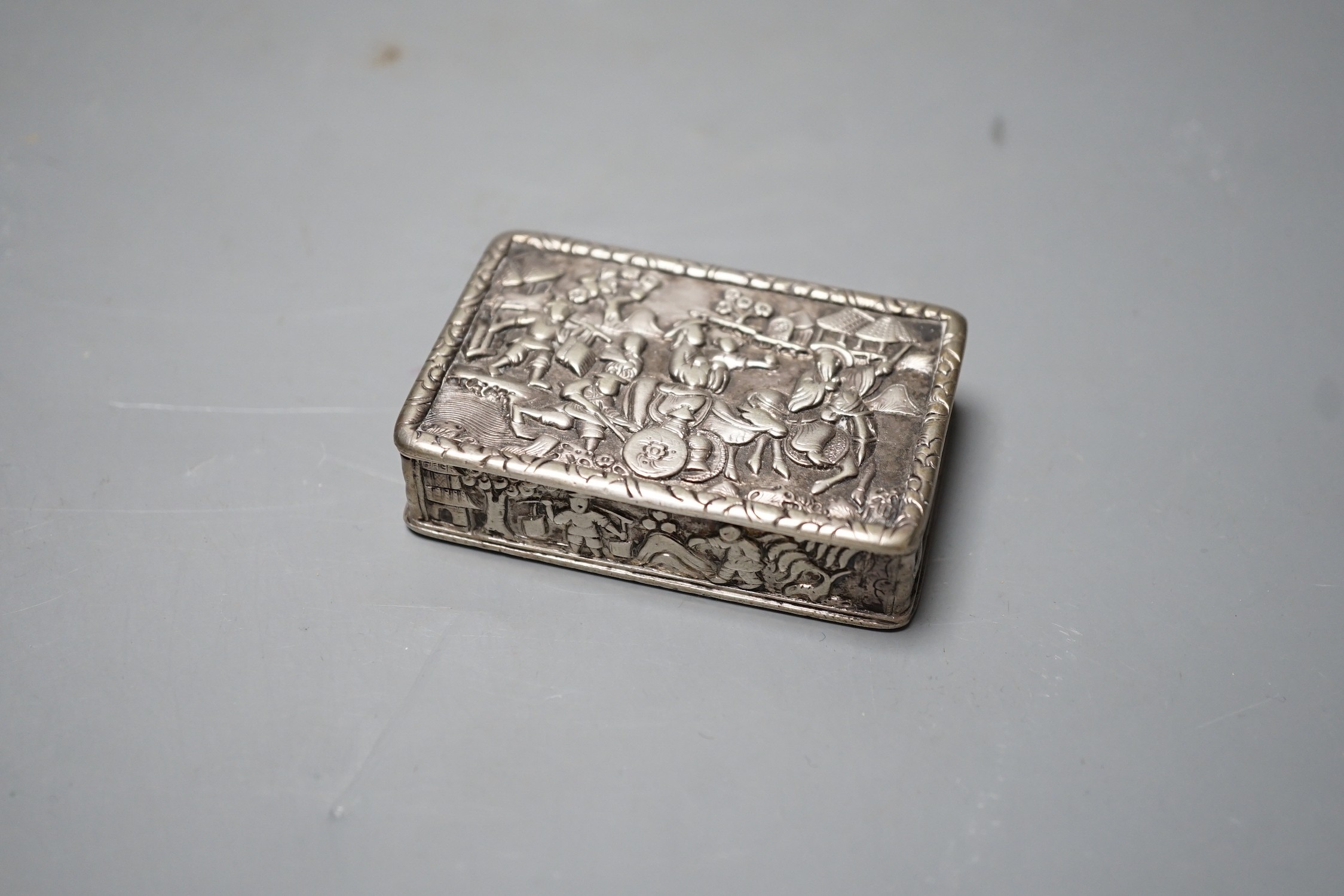 A Chinese export white metal snuff box, maker YS, 66mm, embossed with figures at various pursuits.